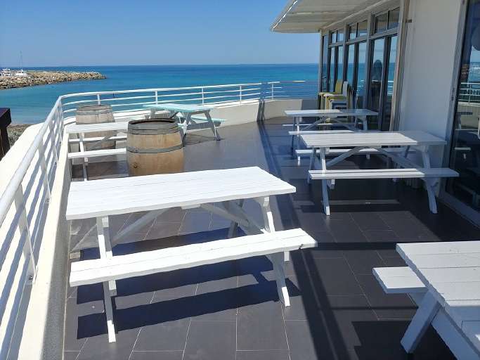 White picnic tables at bathers beach house restaurant