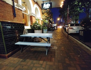 Blue and black painted picnic table at a restaurant in Sydney