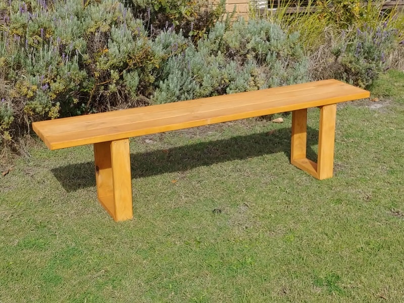 prime-picnic-table-yellow-stained-seating-bench-on-grass-min.jpg